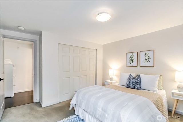 3661 Phinney Ave N Unit 208, Seattle, WA 98103 - bedroom with baseboards, light colored carpet, and a closet
