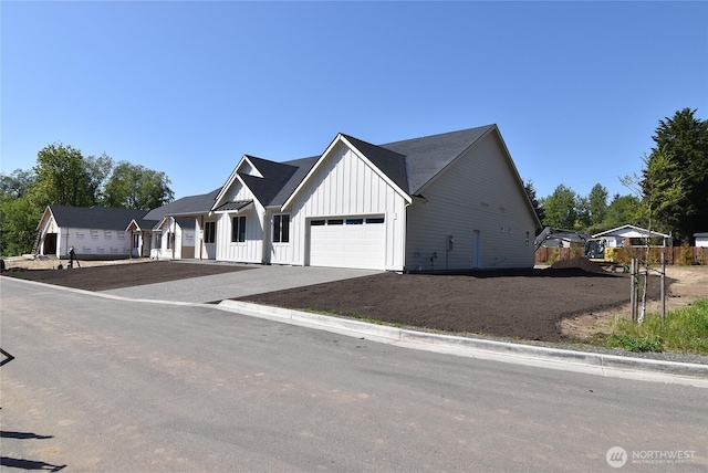 modern inspired farmhouse featuring board and batten siding, driveway, and a garage