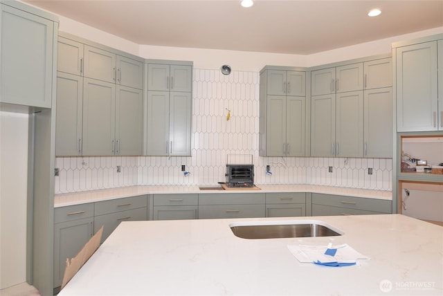 kitchen with recessed lighting, gray cabinetry, and decorative backsplash