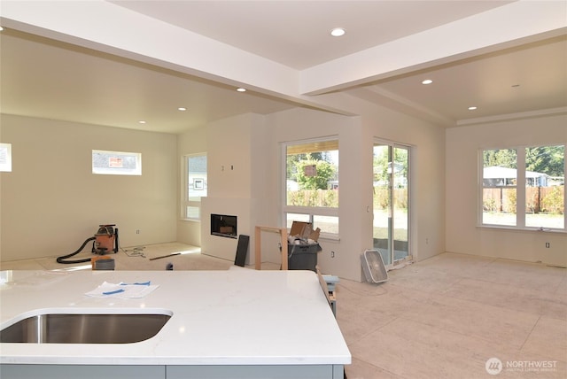 kitchen featuring a fireplace, recessed lighting, and a wealth of natural light
