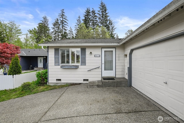 ranch-style house featuring a garage, driveway, and crawl space