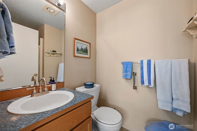 bathroom featuring vanity and toilet
