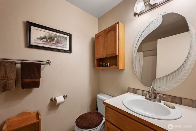 bathroom with toilet and vanity