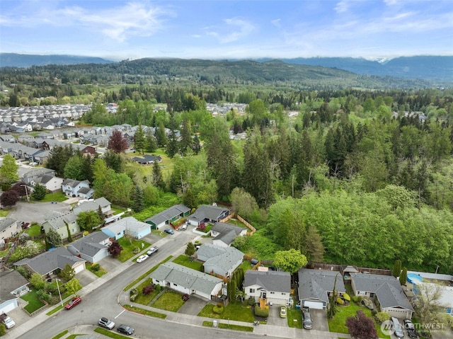 bird's eye view with a view of trees, a residential view, and a mountain view