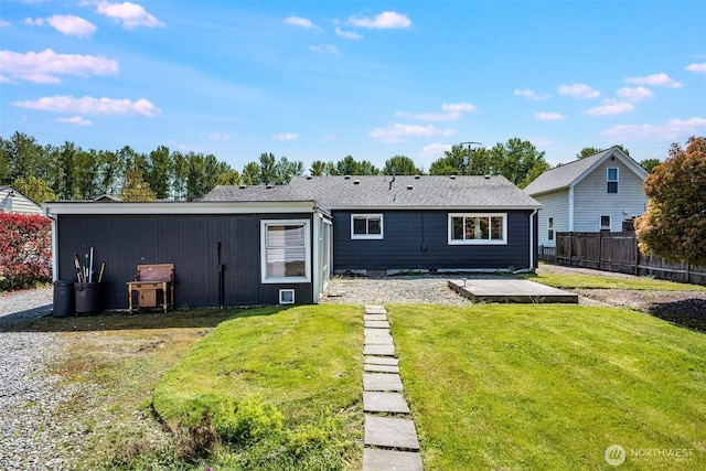 back of house featuring a lawn, a patio area, and fence