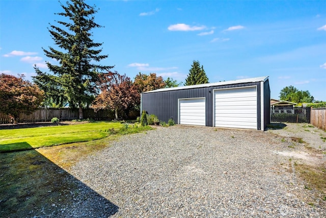 detached garage featuring fence