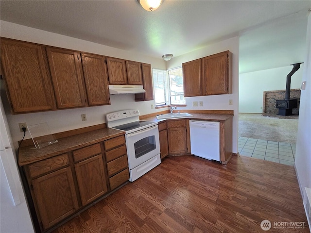 6307 168th St SW, Lynnwood, WA 98037 - kitchen with a sink, white appliances, a wood stove, under cabinet range hood, and dark wood-style floors
