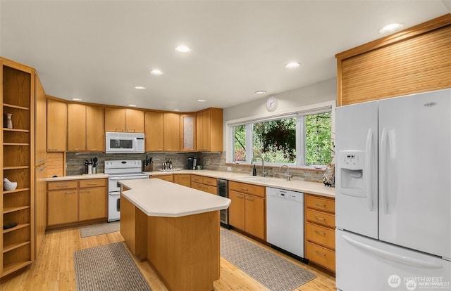 kitchen with decorative backsplash, open shelves, light countertops, light wood-style floors, and white appliances