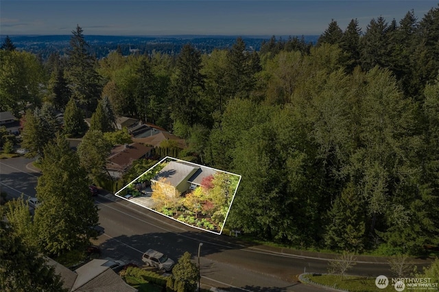 birds eye view of property with a wooded view