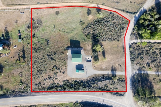 birds eye view of property with a rural view