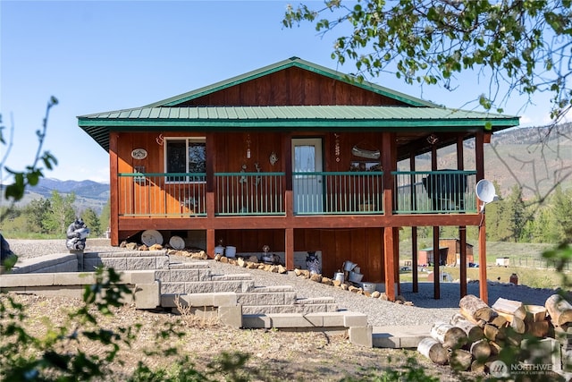 view of front of house featuring metal roof and a mountain view