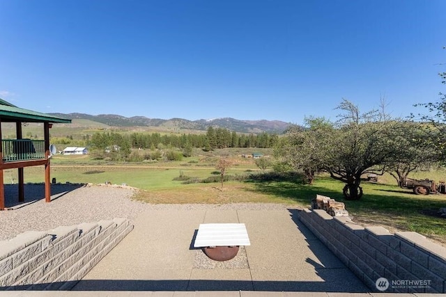 exterior space with a mountain view and a yard
