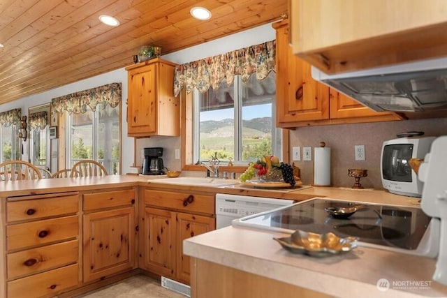 kitchen with light countertops, wood ceiling, a peninsula, and a sink