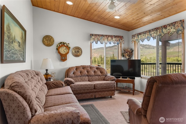 living area featuring carpet flooring, lofted ceiling, a wealth of natural light, and wooden ceiling