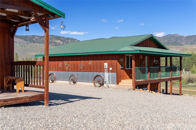 view of front of home with a mountain view and metal roof