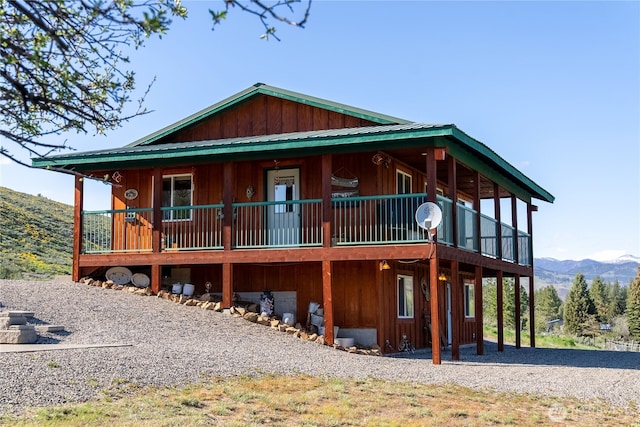 view of front facade with a deck with mountain view