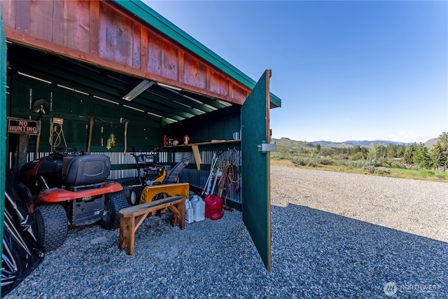 exterior space with an exterior structure, a mountain view, and an outbuilding