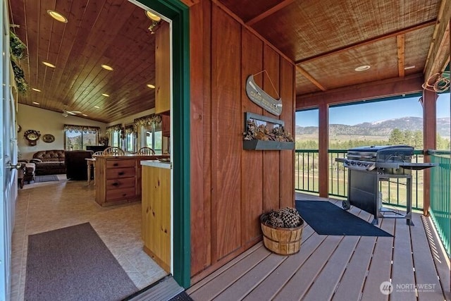 wooden terrace with a mountain view and a grill