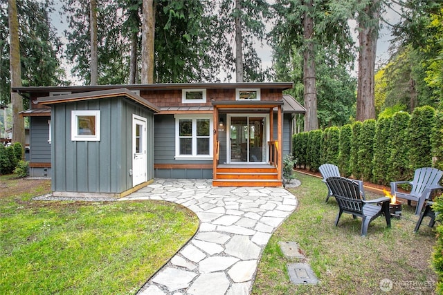 990 S Lake Whatcom Blvd Unit 9, Sedro Woolley, WA 98284 - back of house featuring a patio, board and batten siding, a yard, and an outdoor fire pit