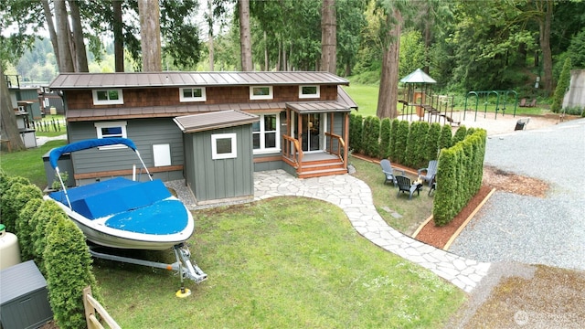 990 S Lake Whatcom Blvd Unit 9, Sedro Woolley, WA 98284 - back of house with board and batten siding, a playground, a yard, and a standing seam roof