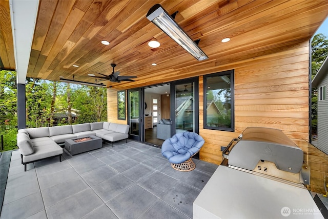 view of patio with an outdoor living space with a fire pit, a ceiling fan, and area for grilling