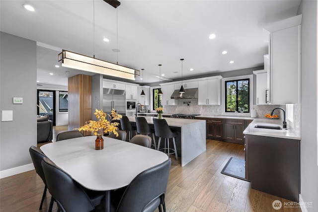 dining room featuring plenty of natural light, recessed lighting, and light wood-style flooring