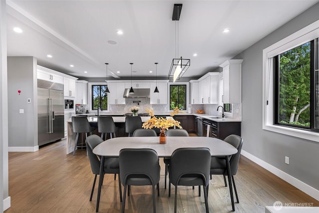 dining area with recessed lighting, baseboards, and wood finished floors