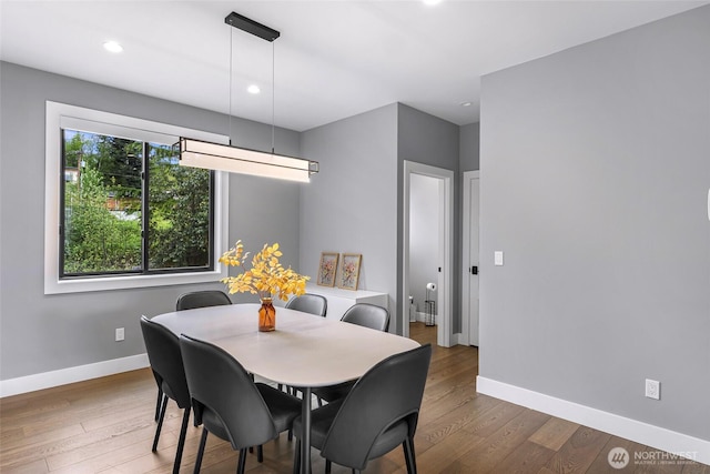 dining room featuring baseboards, recessed lighting, and wood finished floors