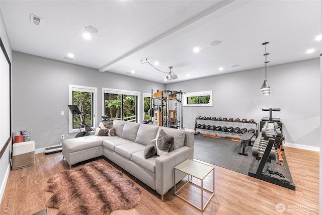 living room featuring recessed lighting, baseboards, visible vents, and wood finished floors