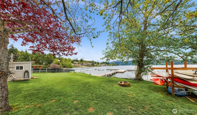 view of yard with fence and an outdoor fire pit