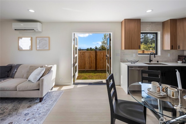 interior space with recessed lighting, light countertops, a wall mounted AC, tasteful backsplash, and a sink