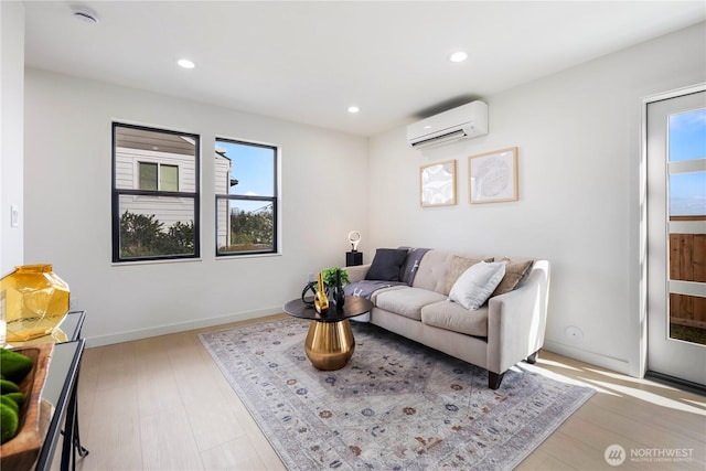 living area featuring a wall mounted AC, recessed lighting, and a wealth of natural light