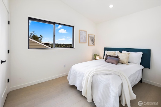 bedroom featuring recessed lighting, baseboards, wood finished floors, and vaulted ceiling