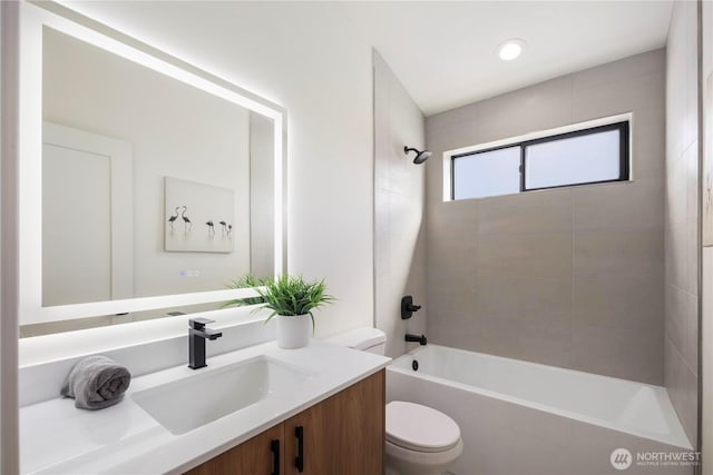 full bath featuring vanity, toilet, and shower / tub combination