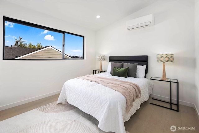 bedroom with recessed lighting, baseboards, a wall mounted AC, and wood finished floors