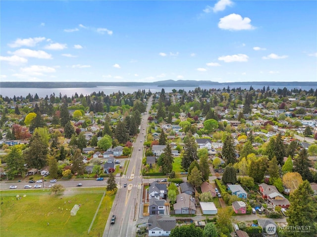 drone / aerial view with a water view and a residential view