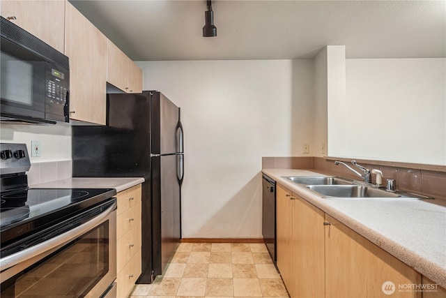 412 11th Ave, Seattle, WA 98122 - kitchen with black appliances, a sink, light brown cabinets, and light countertops