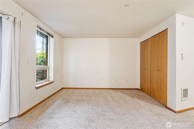 412 11th Ave, Seattle, WA 98122 - unfurnished bedroom with light carpet, baseboards, and a closet
