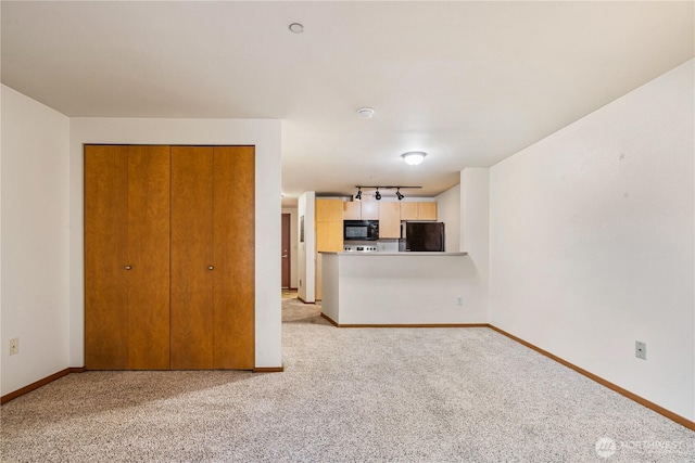412 11th Ave, Seattle, WA 98122 - unfurnished living room featuring baseboards and light carpet