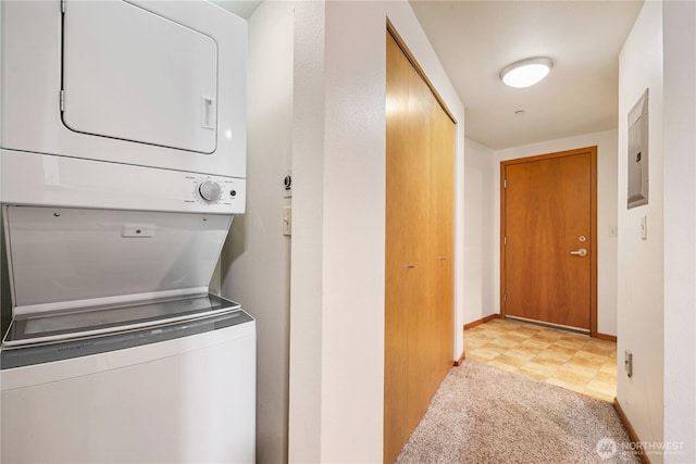 412 11th Ave, Seattle, WA 98122 - laundry room featuring estacked washer and dryer, electric panel, baseboards, and light colored carpet