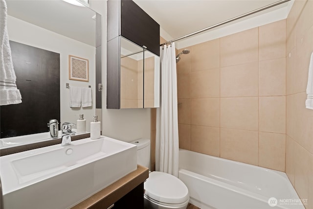 bathroom featuring toilet, shower / bath combination with curtain, and vanity
