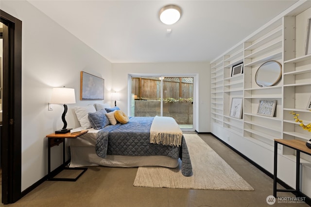 bedroom with baseboards and access to outside