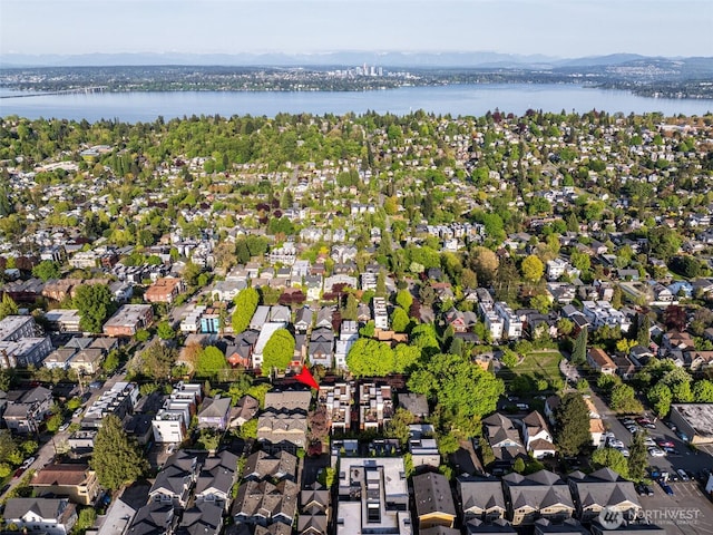 drone / aerial view with a water view and a residential view