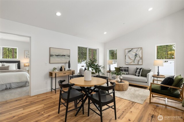 dining space featuring light wood-style floors, recessed lighting, lofted ceiling, and a healthy amount of sunlight