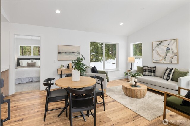 dining space featuring recessed lighting, baseboards, vaulted ceiling, and light wood finished floors