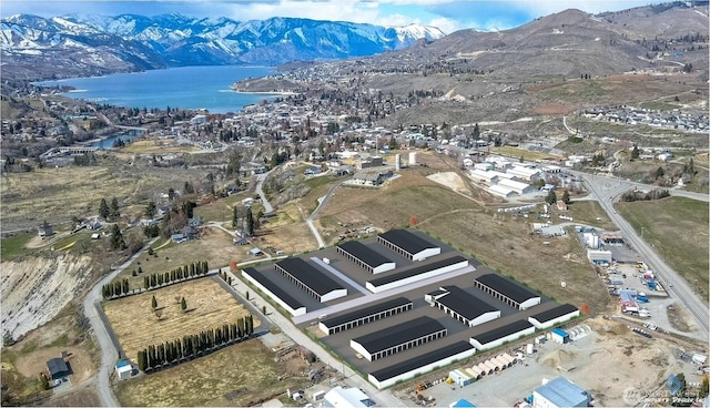 birds eye view of property featuring a water and mountain view