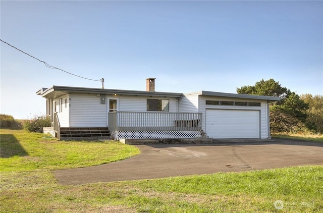 420W Lough Ln, Westport, WA 98595 - ranch-style home featuring an attached garage, a deck, a chimney, aphalt driveway, and a front lawn