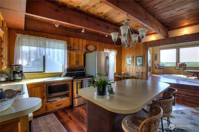 420W Lough Ln, Westport, WA 98595 - kitchen with brown cabinetry, a sink, wood ceiling, stainless steel appliances, and beam ceiling