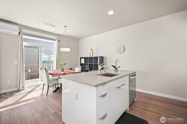 4818 Springside St, Bellingham, WA 98226 - kitchen with light wood-style flooring, modern cabinets, a kitchen island with sink, stainless steel dishwasher, and white cabinetry