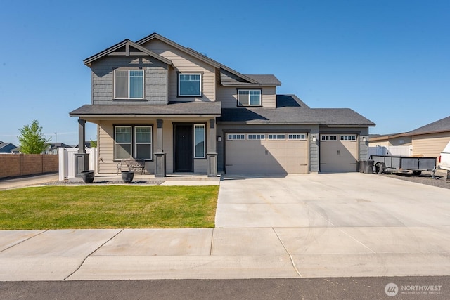 craftsman house with an attached garage, fence, a front yard, concrete driveway, and a porch